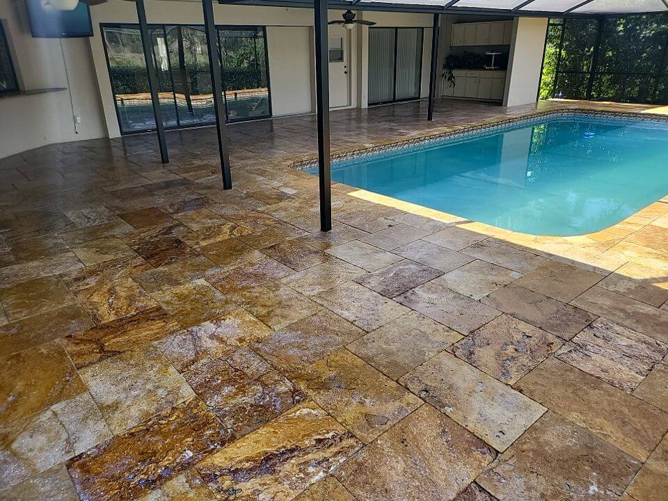 Travertine pool deck cleaned and sealed in Plant City